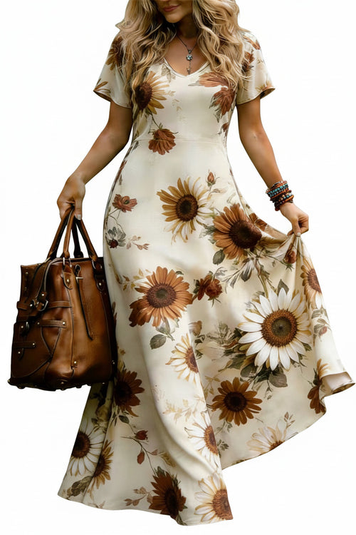 Front view of a woman wearing a cream sunflower floral V-neck maxi dress