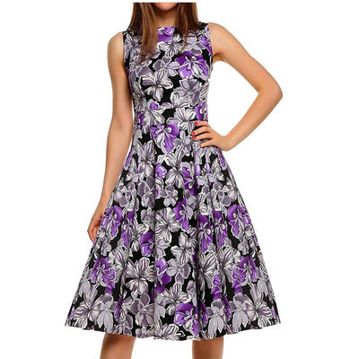 Front view of woman wearing a purple vintage floral A-line midi dress