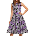 Front view of woman wearing a purple vintage floral A-line midi dress