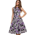 Side profile of a purple off-the-shoulder floral print midi dress